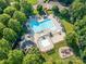 An aerial view highlighting the community pool, pool, cabanas, clubhouse and playground at 15001 Rosemary Way Dr, Huntersville, NC 28078