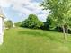 A lush, well-maintained backyard featuring healthy green grass and mature trees at 15001 Rosemary Way Dr, Huntersville, NC 28078
