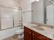 Clean bathroom features a shower/tub combo with glass doors and a vanity with a mirror at 15001 Rosemary Way Dr, Huntersville, NC 28078
