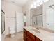 Well-lit bathroom featuring a vanity with sink, toilet, and shower with glass doors at 15001 Rosemary Way Dr, Huntersville, NC 28078