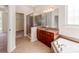 The main bathroom features 2 vanities, tile floors, a shower and soaking tub at 15001 Rosemary Way Dr, Huntersville, NC 28078