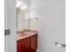 The half bathroom features neutral paint and a cherry vanity at 15001 Rosemary Way Dr, Huntersville, NC 28078