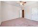 Comfortable bedroom with ceiling fan, soft carpet, and a door to the hallway at 15001 Rosemary Way Dr, Huntersville, NC 28078
