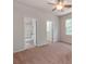 Cozy bedroom with ceiling fan, an ensuite bathroom, and a view to another room at 15001 Rosemary Way Dr, Huntersville, NC 28078