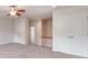 Spacious bedroom featuring a ceiling fan, plush carpet, and multiple closets for ample storage at 15001 Rosemary Way Dr, Huntersville, NC 28078
