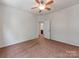 Clean bedroom with neutral walls, ceiling fan, and view to the bathroom at 15001 Rosemary Way Dr, Huntersville, NC 28078