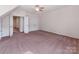 Bright bedroom with open doorway, ceiling fan, neutral walls and closet at 15001 Rosemary Way Dr, Huntersville, NC 28078