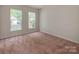 An empty bedroom with 2 windows allowing for plenty of natural light at 15001 Rosemary Way Dr, Huntersville, NC 28078