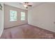 Neutral bedroom with two sunny windows, ceiling fan, and cozy carpet at 15001 Rosemary Way Dr, Huntersville, NC 28078