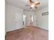 Spacious bedroom with ceiling fan and an open door to the hallway and bathroom at 15001 Rosemary Way Dr, Huntersville, NC 28078