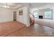 Spacious home entryway featuring tile flooring, staircase, and open access to the living and dining rooms at 15001 Rosemary Way Dr, Huntersville, NC 28078