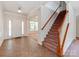 Welcoming entryway with tile floor, staircase, and entry to the living room with large bright windows at 15001 Rosemary Way Dr, Huntersville, NC 28078