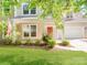 Charming two-story home featuring a cozy front porch, well-kept lawn, and an attached garage at 15001 Rosemary Way Dr, Huntersville, NC 28078