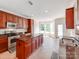 Well-lit kitchen with wood cabinets, granite countertops, tile floors, and stainless steel appliances at 15001 Rosemary Way Dr, Huntersville, NC 28078