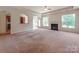 Open living room featuring a fireplace, large windows, and seamless access to the kitchen at 15001 Rosemary Way Dr, Huntersville, NC 28078
