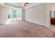 Main bedroom featuring a trey ceiling, carpet, lots of natural light and an adjoining bathroom at 15001 Rosemary Way Dr, Huntersville, NC 28078