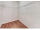A small walk-in closet with shelving and carpeted floors at 15001 Rosemary Way Dr, Huntersville, NC 28078