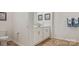 Bathroom with white cabinets, framed art, and warm, neutral colors at 15031 Milo Ln, Charlotte, NC 28278