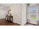 Welcoming entryway with wood floors, console table, and natural light from a window, creating a warm ambiance at 15031 Milo Ln, Charlotte, NC 28278