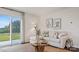 Cozy living room features a sectional sofa, sliding glass door, neutral decor, and wood-style floors at 15031 Milo Ln, Charlotte, NC 28278