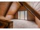Cozy attic space with vaulted ceilings, wood beams, and natural light at 1515 Heatherloch Dr, Gastonia, NC 28054