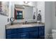 Bathroom featuring a sleek vanity with blue cabinets, marble countertop, and modern fixtures at 1515 Heatherloch Dr, Gastonia, NC 28054