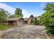 Charming stone house with a spacious driveway and a detached garage, nestled among mature trees at 1515 Heatherloch Dr, Gastonia, NC 28054