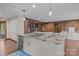Open kitchen layout with a large island, white cabinets, stainless steel appliances, and hardwood floors at 1515 Heatherloch Dr, Gastonia, NC 28054