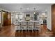 Spacious white kitchen featuring a large island with seating, stainless steel appliances, and hardwood floors at 1515 Heatherloch Dr, Gastonia, NC 28054