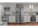 Modern kitchen featuring stainless steel appliances, white cabinetry, and granite countertops at 1515 Heatherloch Dr, Gastonia, NC 28054