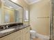 Bathroom featuring granite counters, large mirror, and tiled shower at 1522 High St, Charlotte, NC 28211
