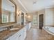 En suite bathroom features double sinks with granite countertops and a soaking tub at 1522 High St, Charlotte, NC 28211