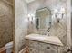Elegant powder room showcasing designer wallpaper, decorative mirror and marble countertop at 1522 High St, Charlotte, NC 28211