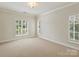 Spacious bedroom features neutral carpet, baseboard molding, and window shutters at 1522 High St, Charlotte, NC 28211