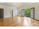 Spacious main bedroom has hardwood floors, crystal chandelier, and balcony access at 1522 High St, Charlotte, NC 28211