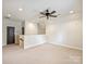 Spacious bonus room featuring a ceiling fan, neutral carpet, and natural light at 1522 High St, Charlotte, NC 28211