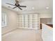 Bonus room with ceiling fan, large bookcase, and built in desk at 1522 High St, Charlotte, NC 28211