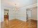 Elegant dining room with hardwood floors, chandelier, and ample natural light at 1522 High St, Charlotte, NC 28211