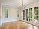 Bright dining room with a chandelier, large windows, and hardwood floors at 1522 High St, Charlotte, NC 28211