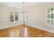 Bright dining room with hardwood floors, plantation shutters, and elegant chandelier at 1522 High St, Charlotte, NC 28211