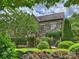 Charming stone home with manicured landscaping and mature trees at 1522 High St, Charlotte, NC 28211