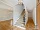 Elegant foyer with hardwood floors, grand staircase, and stylish chandelier at 1522 High St, Charlotte, NC 28211