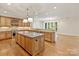 Large kitchen with stainless steel appliances, granite countertops and center island open to dining at 1522 High St, Charlotte, NC 28211