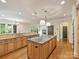 Open-concept kitchen area with granite countertops, stainless appliances, breakfast bar, and hardwood floors at 1522 High St, Charlotte, NC 28211