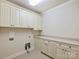 Bright laundry room with ample cabinet space and modern amenities at 1522 High St, Charlotte, NC 28211