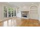 Living room with hardwood floors, fireplace, built-in shelving, and French doors at 1522 High St, Charlotte, NC 28211