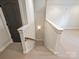 Carpeted staircase with white railing and wood handrail at 1522 High St, Charlotte, NC 28211