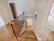 Carpeted staircase with decorative sconce, wood railing, and iron spindles at 1522 High St, Charlotte, NC 28211