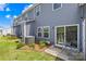 Backyard patio space with sliding door and seating with blue siding at 1563 Old Rivers Rd, Concord, NC 28027