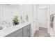 Bright bathroom featuring a double sink vanity with gray cabinets and modern fixtures at 1563 Old Rivers Rd, Concord, NC 28027